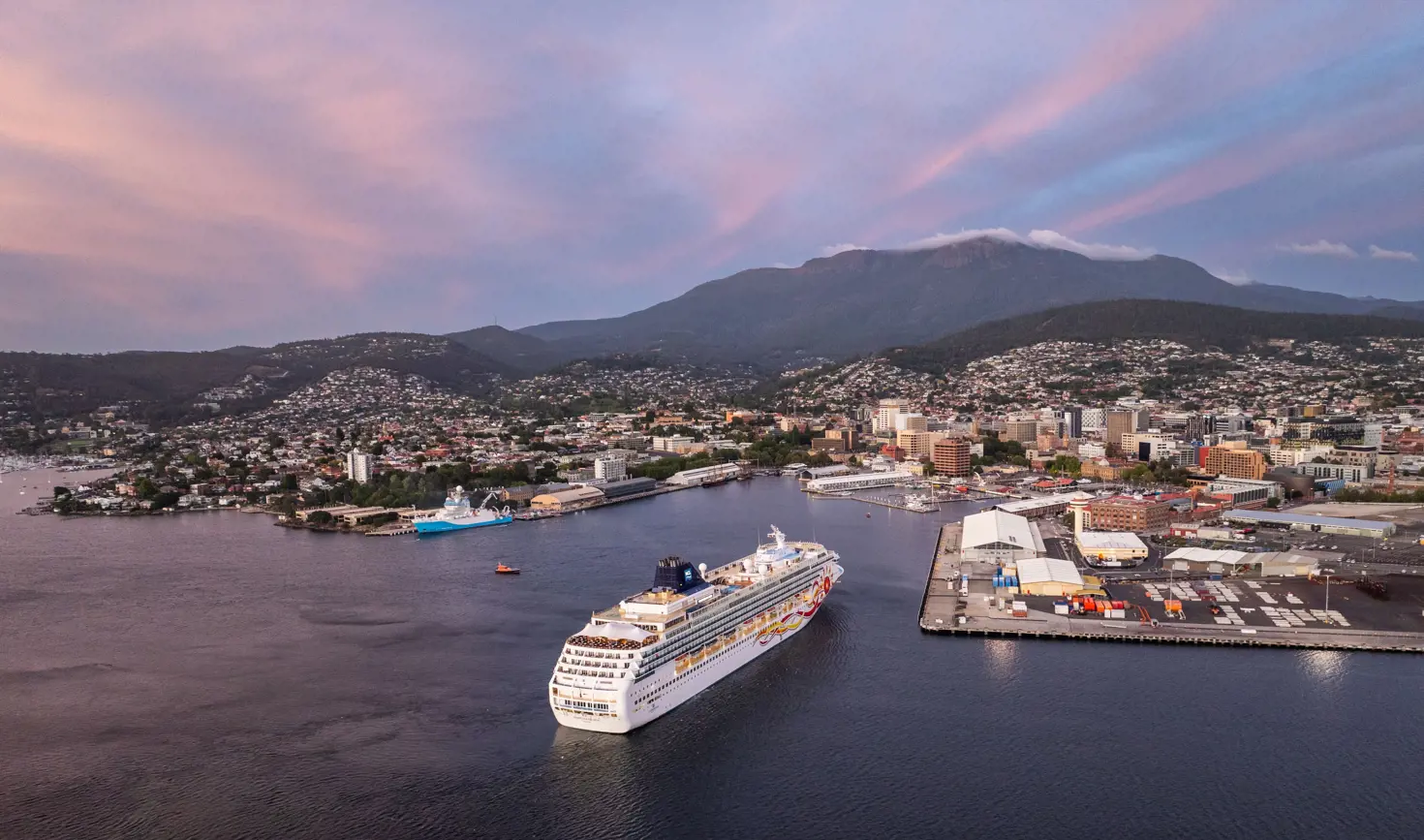 Aerial view of cruise ship Norwegian Sun arriving at Hobart Port with kunanyi / Mount Wellington in the background, Tasmania