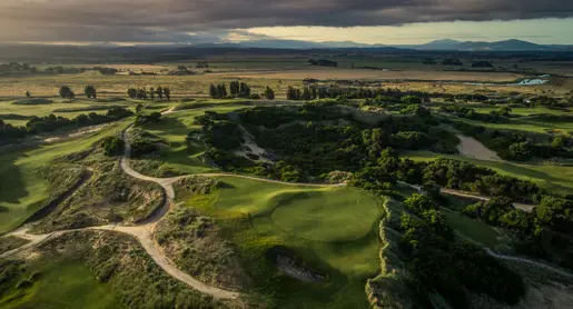 Aerial view of fairways and bunkers winding through coastal dunes at Barnbougle Dunes, Bridport, Tasmania