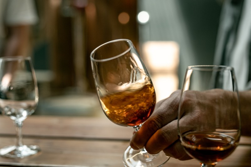 A whisky is swirled in a short stem glass.